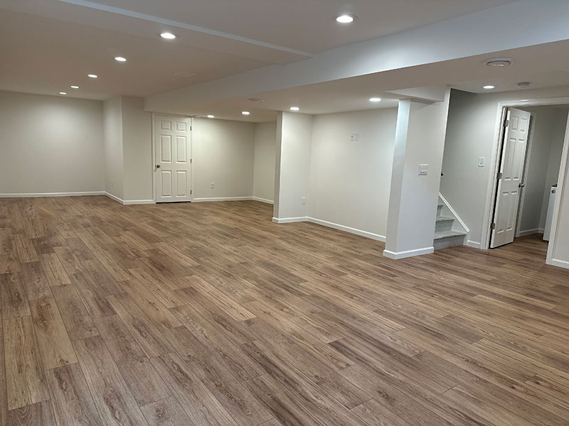 The Basic Basement Co. - Finished Basement with a laundry-utility room, Coretec ProPlus Enhanced Flooring, and Benjamin Moore White Dove Eggshell wall paint and Simply White Semi-Gloss door and trim paint - Newtown, Pennsylvania - October 2023