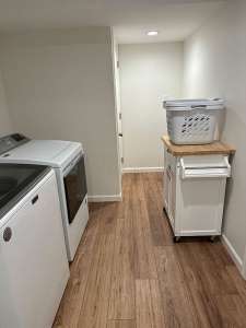 The Basic Basement Co. - Finished Basement with a laundry-utility room, Coretec ProPlus Enhanced Flooring, and Benjamin Moore White Dove Eggshell wall paint and Simply White Semi-Gloss door and trim paint - Newtown, Pennsylvania - October 2023